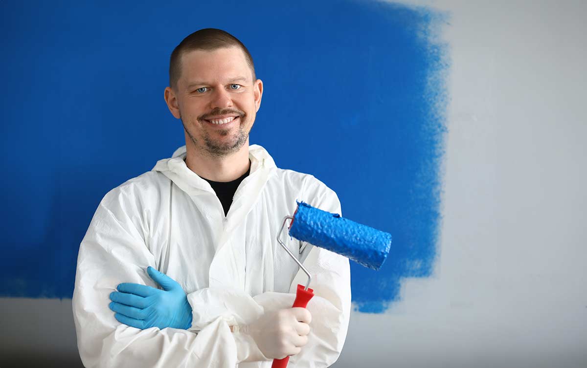 male painter uniform with roller his hand 1200